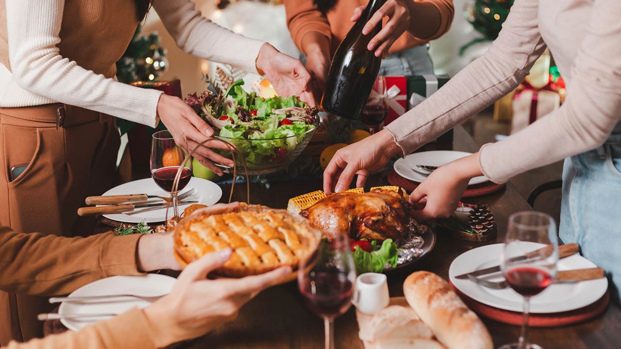 Group of young adult Asian Friends holiday party dinner at home around the table